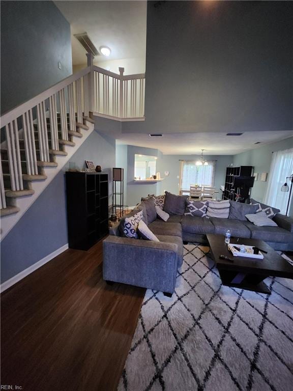 515 Burton St, Hampton, VA 23666 - living area with wood finished floors, stairs, a chandelier, and a towering ceiling