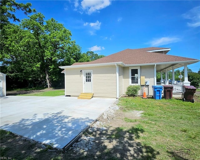 208 George Washington Hwy N, Chesapeake, VA 23323 - view of home's exterior with entry steps, a patio area, a lawn, and roof with shingles