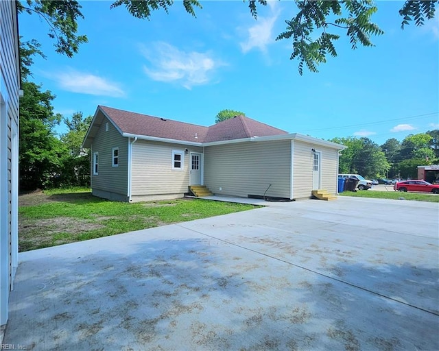 208 George Washington Hwy N, Chesapeake, VA 23323 - rear view of property with entry steps, driveway, and a lawn