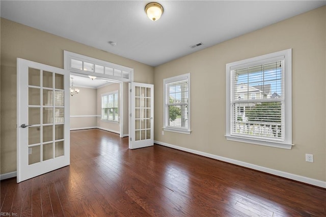 3217 Meanley Dr, Chesapeake, VA 23323 - unfurnished room featuring a chandelier, baseboards, wood finished floors, and french doors