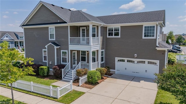 3217 Meanley Dr, Chesapeake, VA 23323 - view of front of property with a garage, a porch, driveway, a balcony, and fence