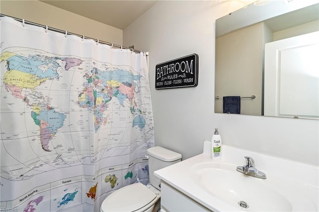 bathroom featuring vanity, toilet, and a shower with curtain