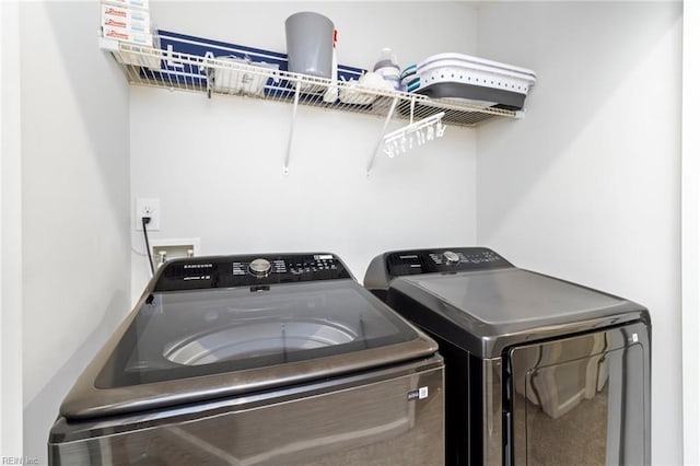 clothes washing area featuring independent washer and dryer