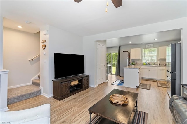 living room with light wood finished floors, stairs, ceiling fan, baseboards, and recessed lighting
