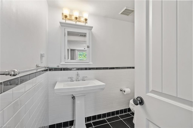 1506 Colonial Ave Unit 9, Norfolk, VA 23517 - bathroom featuring tile patterned flooring, toilet, wainscoting, and tile walls