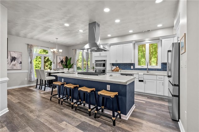 2300 Perez Way, Virginia Beach, VA 23456 - kitchen with island exhaust hood, baseboards, appliances with stainless steel finishes, a chandelier, and light countertops