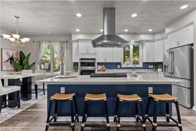 2300 Perez Way, Virginia Beach, VA 23456 - kitchen featuring stainless steel appliances, island range hood, light countertops, healthy amount of natural light, and recessed lighting