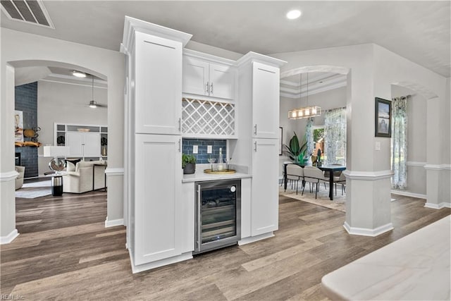 2300 Perez Way, Virginia Beach, VA 23456 - indoor dry bar featuring wine cooler, light wood finished floors, arched walkways, recessed lighting, and baseboards
