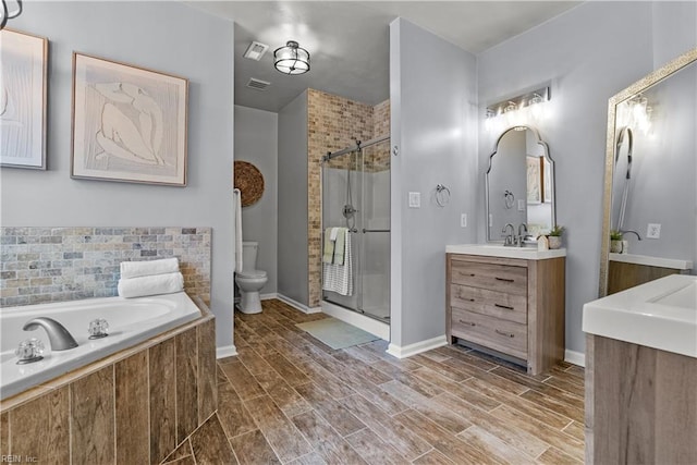 2300 Perez Way, Virginia Beach, VA 23456 - full bath featuring a shower stall, vanity, toilet, a garden tub, and wood finished floors