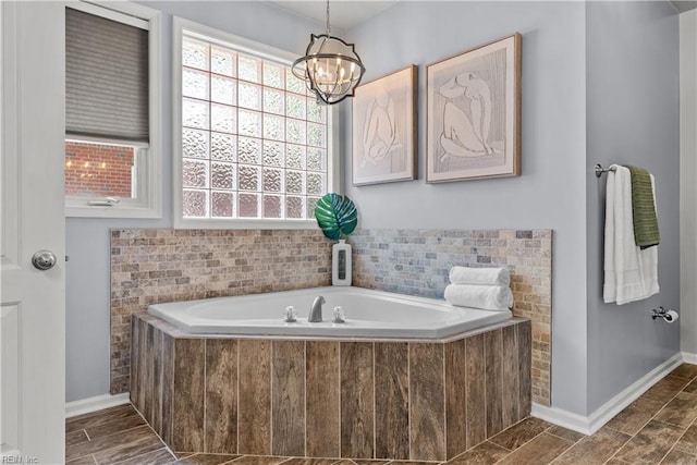 2300 Perez Way, Virginia Beach, VA 23456 - bathroom featuring a bath, a chandelier, and baseboards