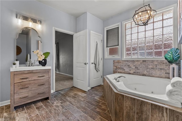 2300 Perez Way, Virginia Beach, VA 23456 - bathroom with a chandelier, vanity, a tub with jets, wood finish floors, and baseboards