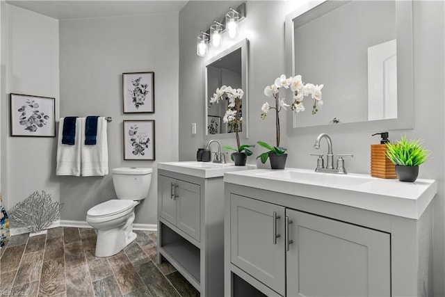 2300 Perez Way, Virginia Beach, VA 23456 - full bath with toilet, two vanities, baseboards, and wood finish floors