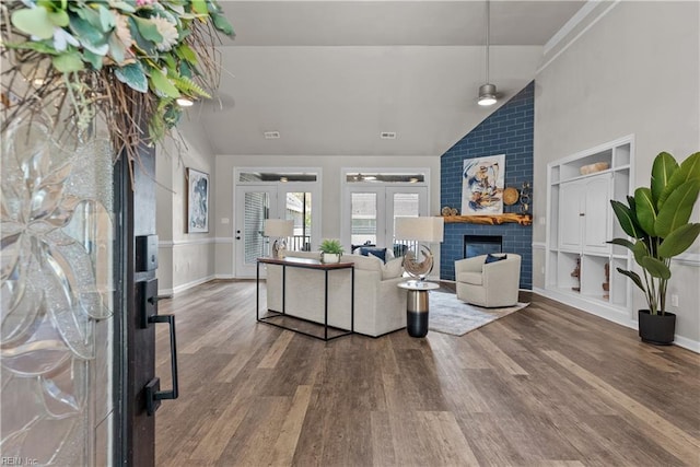 2300 Perez Way, Virginia Beach, VA 23456 - living area with vaulted ceiling, french doors, wood finished floors, a brick fireplace, and baseboards