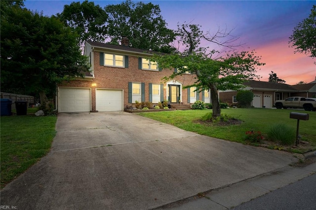 4769 Marlborough Dr, Virginia Beach, VA 23464 - colonial-style house with a garage, driveway, a front yard, a chimney, and brick siding
