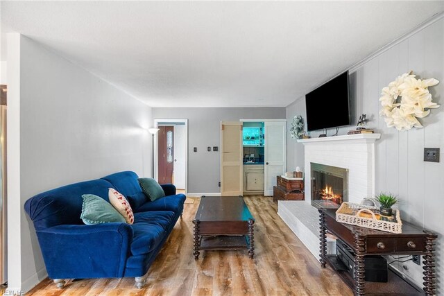 4769 Marlborough Dr, Virginia Beach, VA 23464 - living room with wood finished floors, a brick fireplace, and baseboards