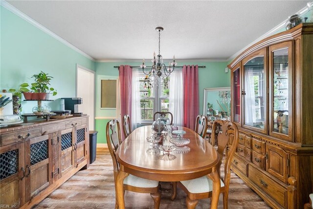 4769 Marlborough Dr, Virginia Beach, VA 23464 - dining area featuring a chandelier, light wood-type flooring, ornamental molding, and healthy amount of natural light