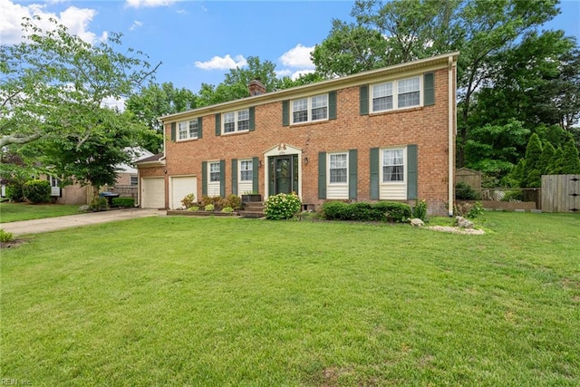4769 Marlborough Dr, Virginia Beach, VA 23464 - colonial home featuring concrete driveway, a chimney, and brick siding
