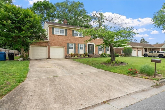 4769 Marlborough Dr, Virginia Beach, VA 23464 - colonial-style house with brick siding, a garage, driveway, a front yard, and a chimney