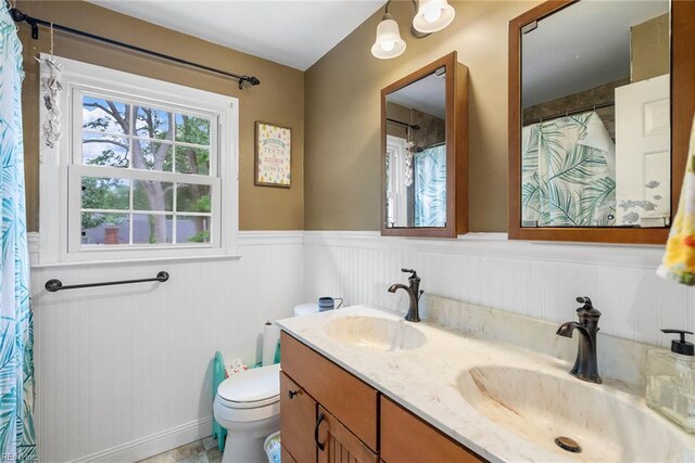 4769 Marlborough Dr, Virginia Beach, VA 23464 - full bathroom with a wainscoted wall, toilet, double vanity, and a shower with shower curtain