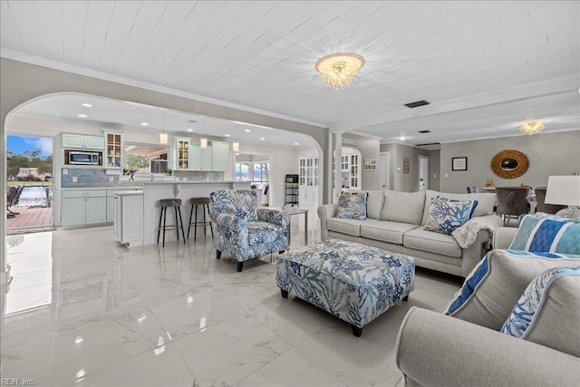 living area with arched walkways, crown molding, light marble finish floors, and wooden ceiling