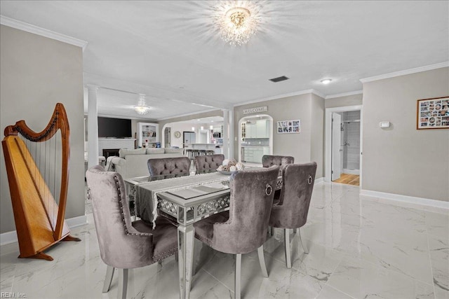 dining area featuring baseboards, light marble finish flooring, ornamental molding, and a fireplace