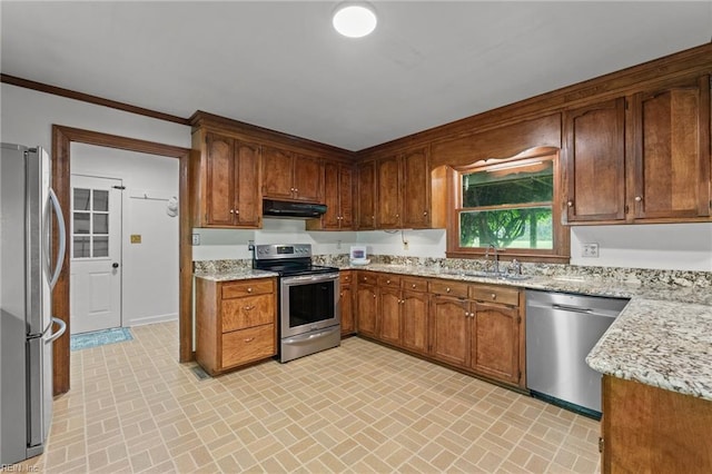 104 Beechwood Dr, Franklin, VA 23851 - kitchen with stainless steel appliances, under cabinet range hood, brick patterned floors, a sink, and ornamental molding