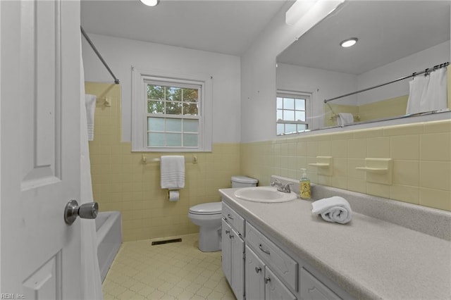 104 Beechwood Dr, Franklin, VA 23851 - bathroom featuring toilet, vanity, tile walls, a wainscoted wall, and shower / bath combination with curtain