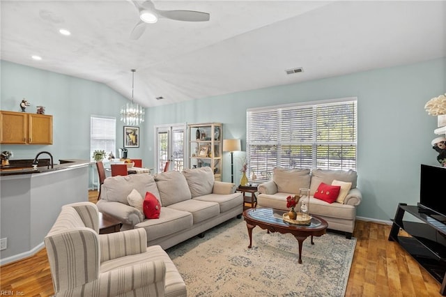 2777 Livingston Loop, Virginia Beach, VA 23456 - living area with vaulted ceiling, a chandelier, light wood-type flooring, ceiling fan, and baseboards
