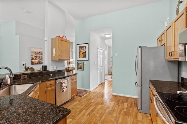 2777 Livingston Loop, Virginia Beach, VA 23456 - kitchen with appliances with stainless steel finishes, a sink, light wood-type flooring, and dark stone countertops