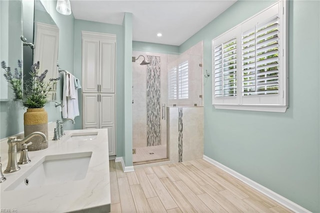 2777 Livingston Loop, Virginia Beach, VA 23456 - bathroom with baseboards, a stall shower, wood finished floors, double vanity, and recessed lighting