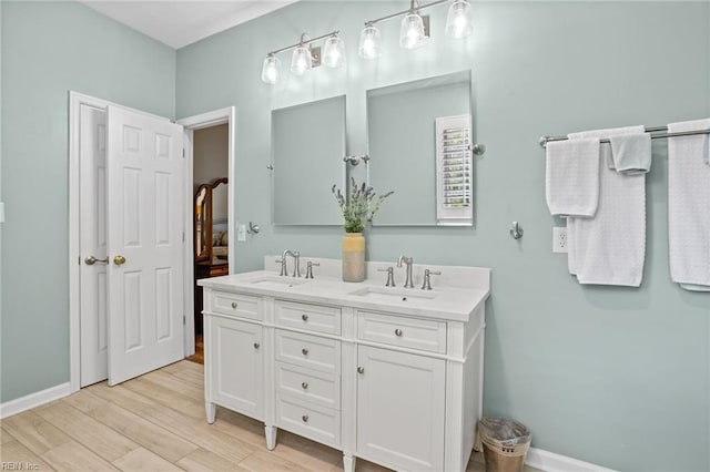 2777 Livingston Loop, Virginia Beach, VA 23456 - bathroom featuring wood finished floors, double vanity, and baseboards