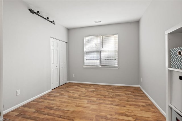 2777 Livingston Loop, Virginia Beach, VA 23456 - unfurnished bedroom featuring light wood-type flooring, baseboards, and a closet