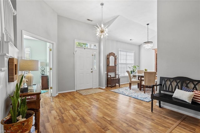 2777 Livingston Loop, Virginia Beach, VA 23456 - foyer with a chandelier, light wood-style flooring, a towering ceiling, and baseboards