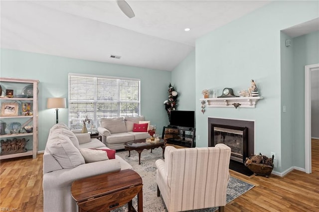 2777 Livingston Loop, Virginia Beach, VA 23456 - living area with wood finished floors, a glass covered fireplace, baseboards, lofted ceiling, and a ceiling fan