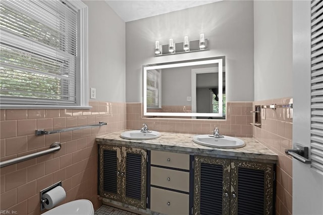 1508 Reynard Rd, Suffolk, VA 23433 - bathroom with tile walls, toilet, wainscoting, double vanity, and tile patterned flooring