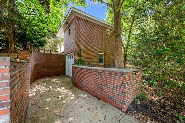 1508 Reynard Rd, Suffolk, VA 23433 - view of property exterior with driveway, an attached garage, brick siding, and fence