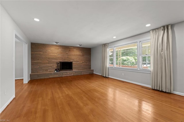1508 Reynard Rd, Suffolk, VA 23433 - unfurnished living room with a stone fireplace, wood finished floors, baseboards, and recessed lighting