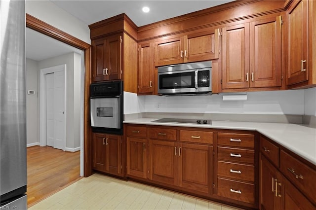 1508 Reynard Rd, Suffolk, VA 23433 - kitchen featuring appliances with stainless steel finishes, light countertops, light wood-style flooring, brown cabinets, and recessed lighting