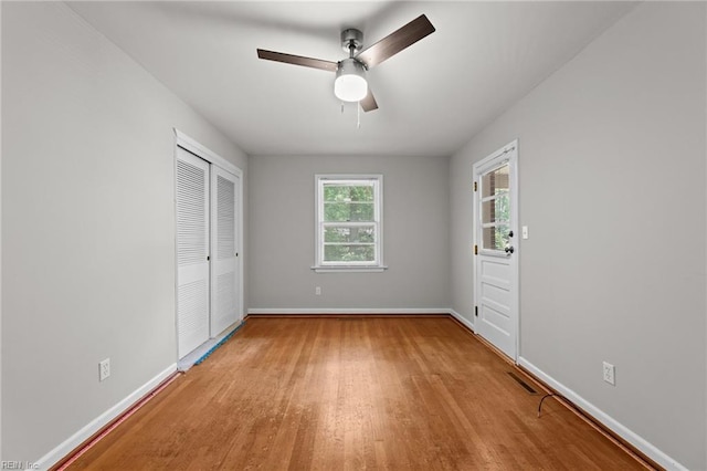 1508 Reynard Rd, Suffolk, VA 23433 - unfurnished bedroom with wood finished floors, baseboards, a closet, and ceiling fan
