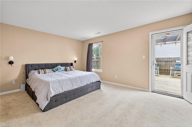 bedroom featuring carpet floors, baseboards, and a textured ceiling