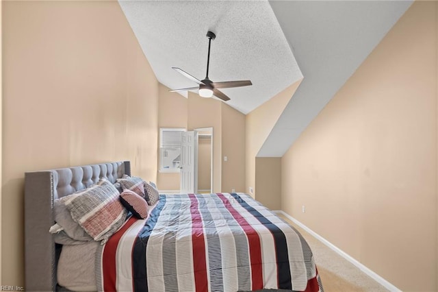 bedroom with lofted ceiling, carpet flooring, a textured ceiling, baseboards, and a ceiling fan