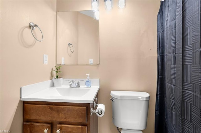 bathroom with vanity, toilet, and a shower with curtain