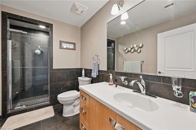 4250 Granby St Unit 106, Norfolk, VA 23504 - bathroom featuring tile walls, a stall shower, vanity, toilet, and tile patterned flooring