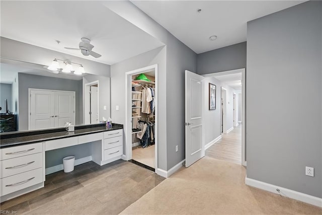 4250 Granby St Unit 106, Norfolk, VA 23504 - bathroom featuring baseboards, vanity, wood finished floors, a ceiling fan, and a spacious closet