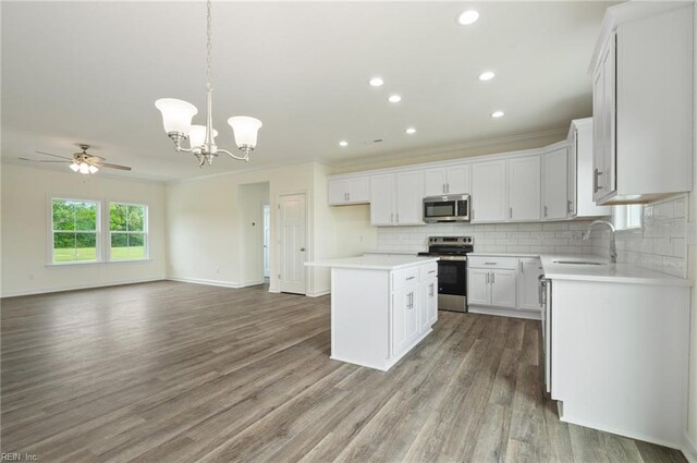 104 Pailin Creek Rd, Elizabeth City, NC 27909 - kitchen with appliances with stainless steel finishes, open floor plan, crown molding, wood finished floors, and tasteful backsplash