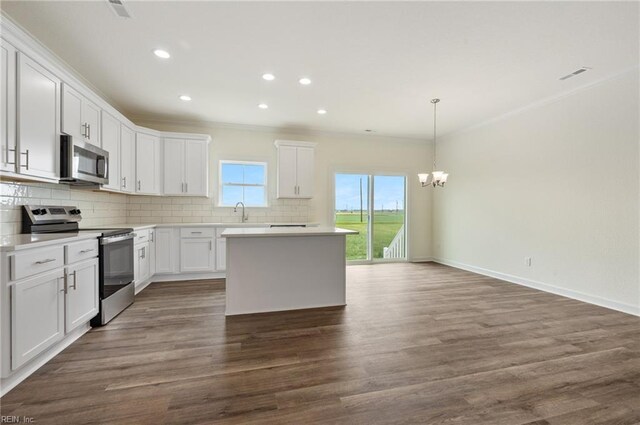 104 Pailin Creek Rd, Elizabeth City, NC 27909 - kitchen featuring appliances with stainless steel finishes, a chandelier, crown molding, tasteful backsplash, and a kitchen island