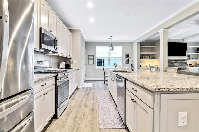 3820 Whites Lndg, Chesapeake, VA 23321 - kitchen featuring stainless steel appliances, a sink, light wood-style floors, tasteful backsplash, and crown molding