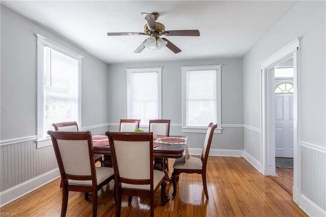 113 E Virginia Ave, Hampton, VA 23663 - dining space featuring light wood-type flooring, healthy amount of natural light, wainscoting, and a ceiling fan