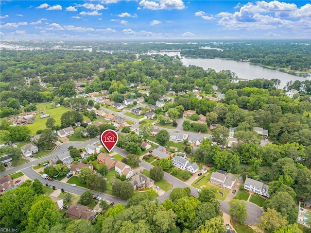 aerial view of residential area featuring a large body of water