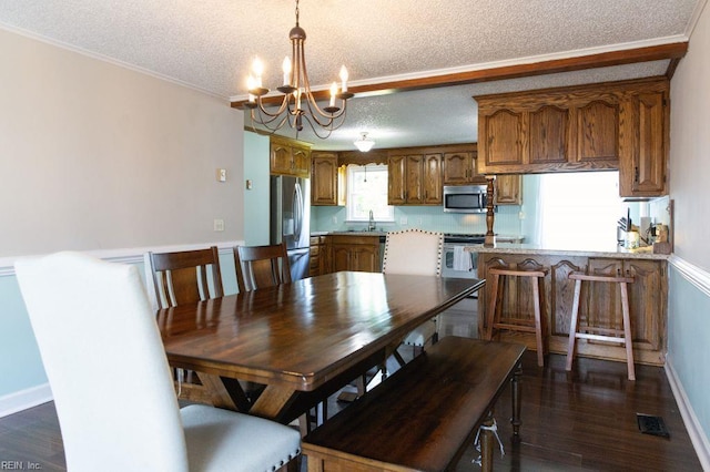 125 Messick Rd, Poquoson, VA 23662 - dining room with a textured ceiling, a chandelier, dark wood-style floors, baseboards, and crown molding